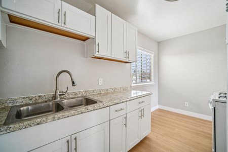 A kitchen with a sink and cabinets.